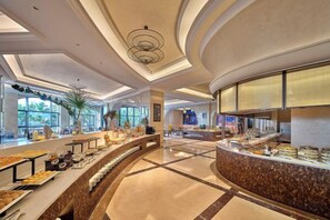 A spacious buffet area with a curved counter, large windows, and a modern ceiling design. - DoubleTree by Hilton Sanya Bay (Sanya)
