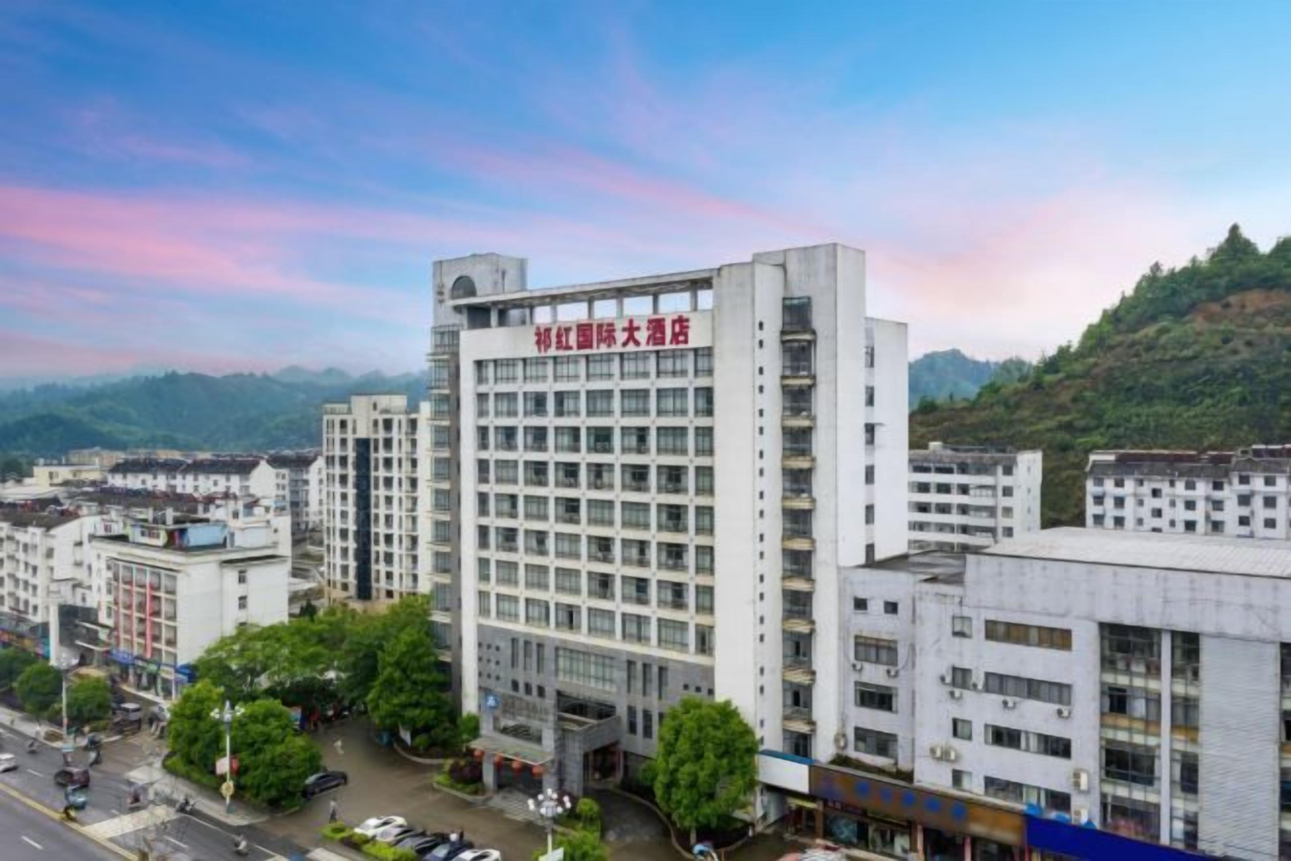A multi-story building with a prominent sign at the top.