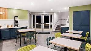 A modern kitchen with a coffee machine, a counter with a coffee dispenser, and a set of cabinets. - Spark by Hilton Williams (Williams)
