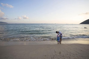 A beach with a person standing by the water. - Sanya Dadonghai Jiahe Apartment (Summer Department Store) (Sanya)