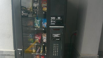 A vending machine with snacks and a coin slot.