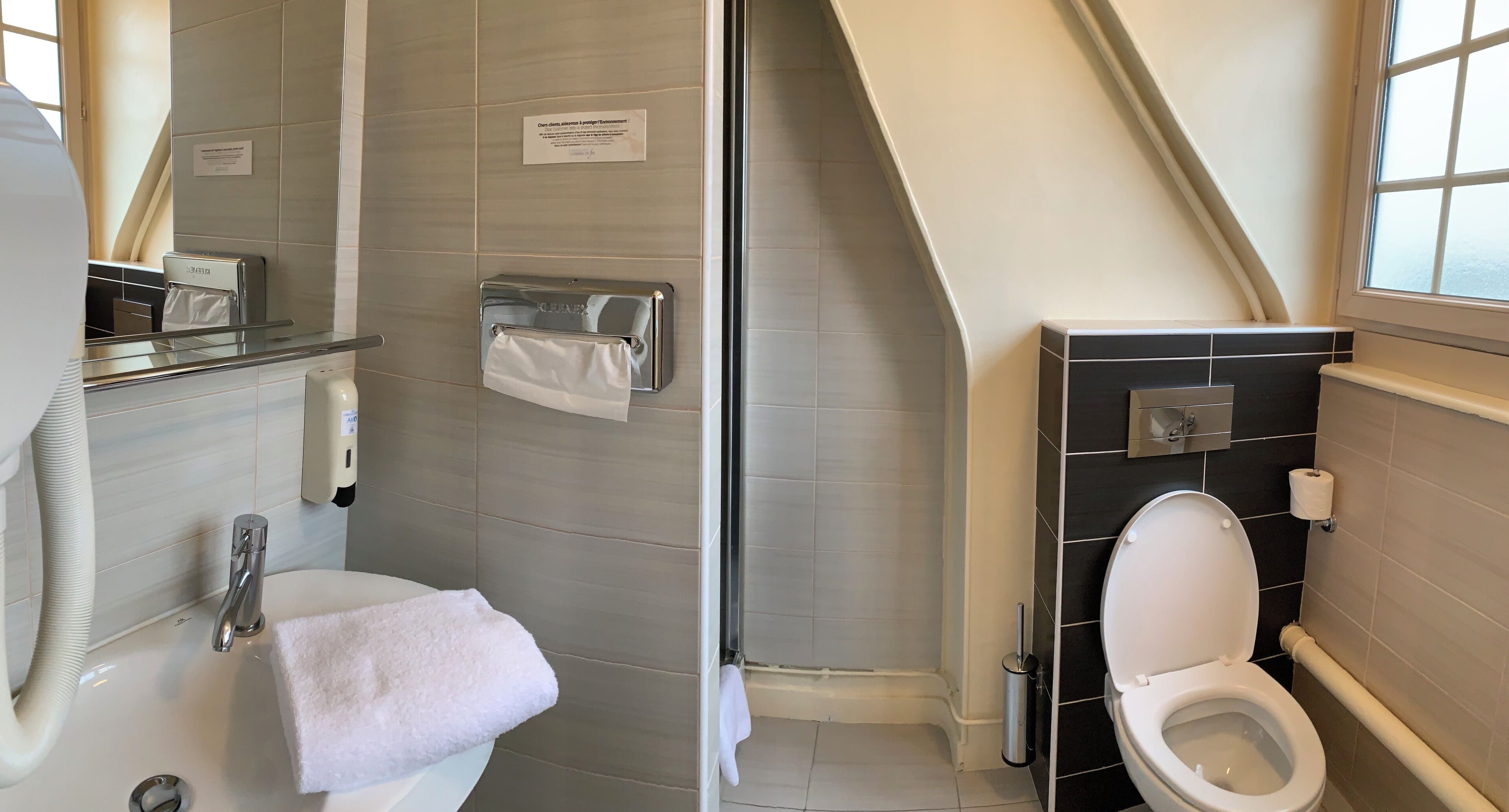 Un baño moderno con ducha, inodoro y lavamanos.