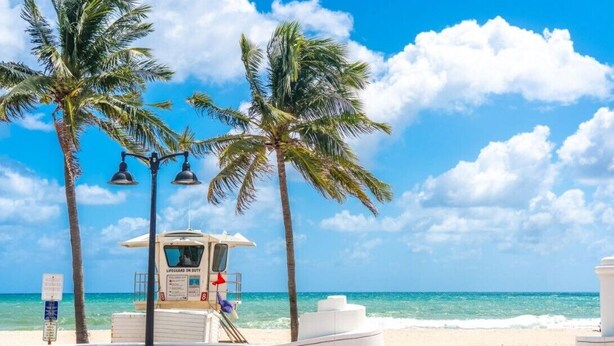 A lifeguard tower on a beach with palm trees and a clear blue sky. - Fort Lauderdale Beach Resort 1 Bedroom Suite; RATES ARE NEGOTIABLE!!! (Fort Lauderdale)