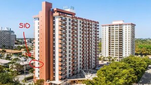 A high-rise hotel with multiple floors, balconies, and a swimming pool area. - Fort Lauderdale Beach Resort 1 Bedroom Suite; RATES ARE NEGOTIABLE!!! (Fort Lauderdale)