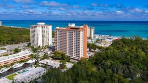 A high-rise hotel with multiple floors, located near a beach with clear blue waters. - Fort Lauderdale Beach Resort 1 Bedroom Suite; RATES ARE NEGOTIABLE!!! (Fort Lauderdale)