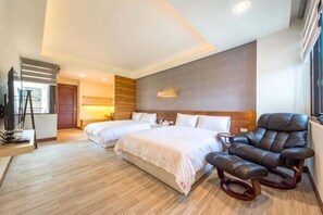 A hotel room with two beds, a massage chair, a TV, and a large window. - Taitung Yipin Garden Bed and Breakfast (Taitung)
