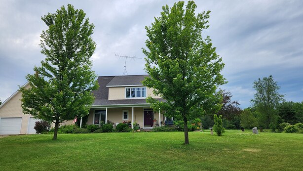 A residential house with a front yard, a satellite dish, and a clear sky. - Sweetfern Inn (Clare)