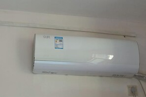 A wall-mounted air conditioning unit with a control panel and a label. - Suya Inn (Changting Yingbei Street) (Changting)