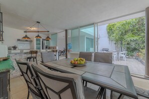 A modern kitchen with a dining area.