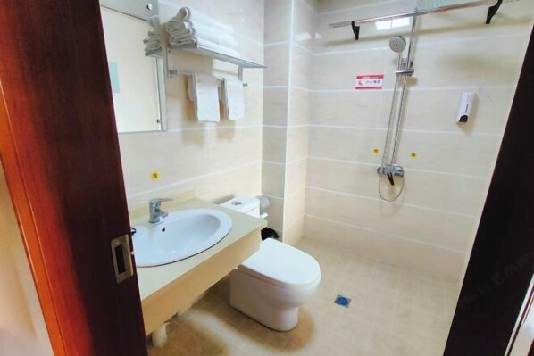 A bathroom with a sink, toilet, and shower. - Furui Hotel (Lichuan)
