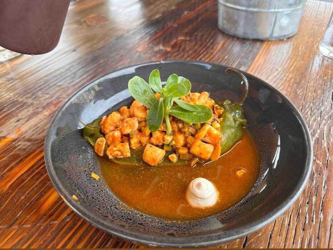 A bowl of food on a wooden table.