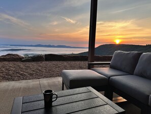 Relax in a serene outdoor seating area with a breathtaking view of the surrounding mountains.