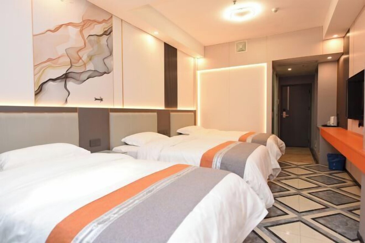 A hotel room with two beds, a modern design, and a tiled floor.