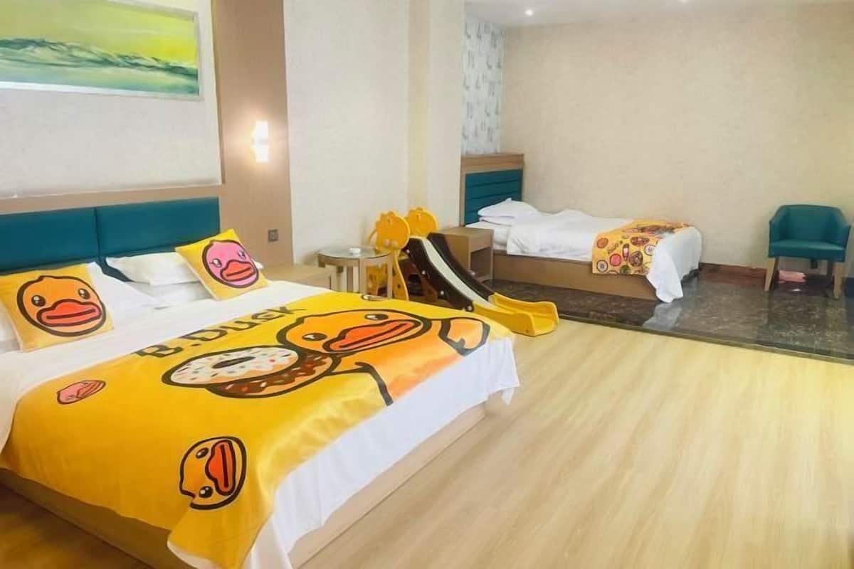 Une chambre d’hôtel avec un lit, une chaise, une petite table et un tableau au mur.