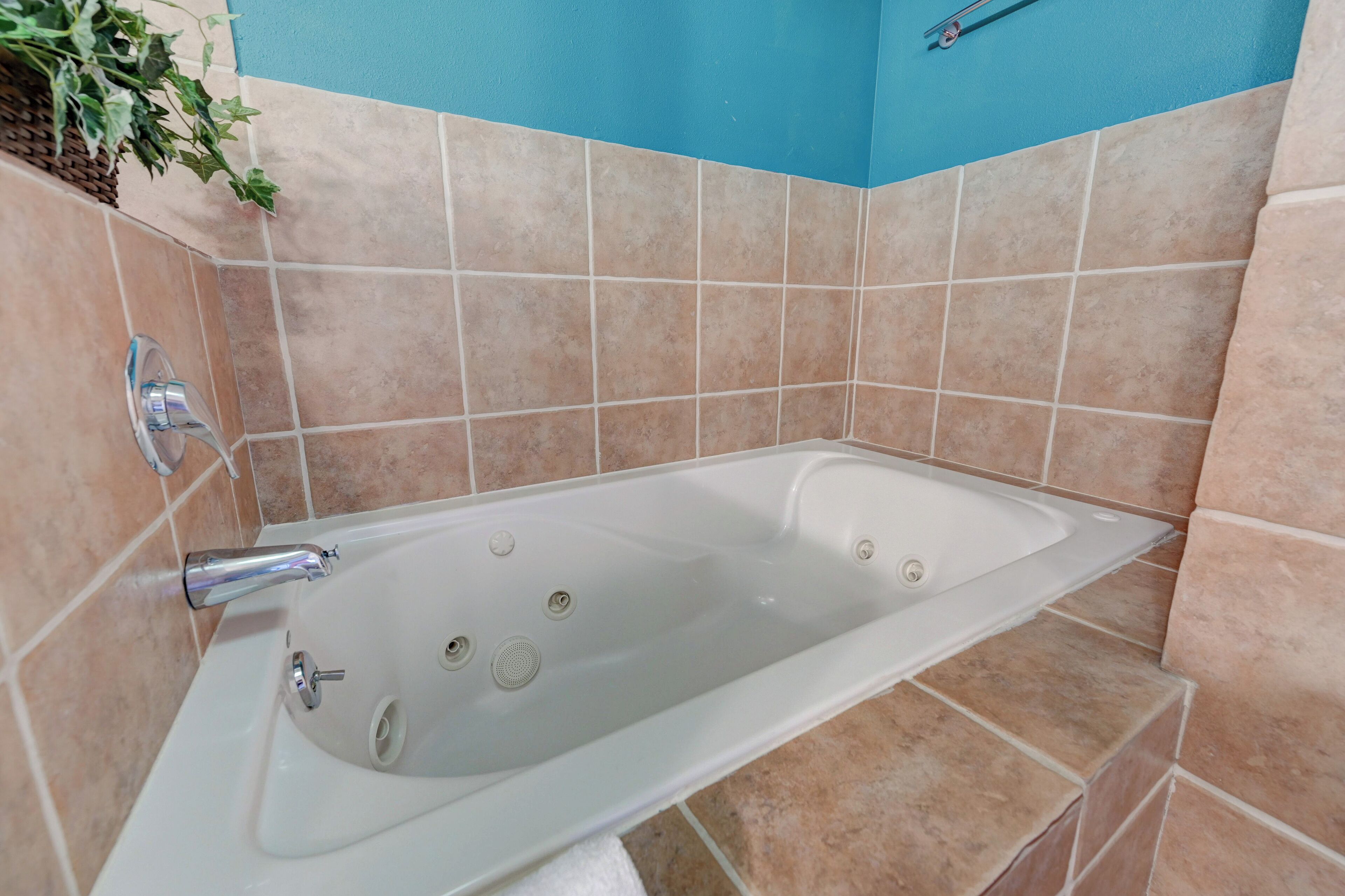 A bathroom with a bathtub, a shower, and a sink.