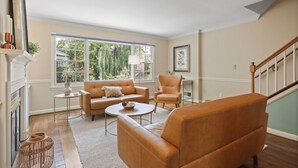 A living room with a fireplace, a sofa, a chair, and a coffee table.