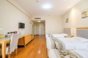 A hotel room with a wooden desk, two beds, a television, and artwork on the walls. - Loulan Hotel (Liaocheng Bus Terminal Wanda Plaza) (Liaocheng)