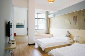 A hotel room with two beds, a television, a window, and a wall with artwork. - Wuyishan Half Mountain and Half Water (Zen culture theme) Hotel (Wuyishan)