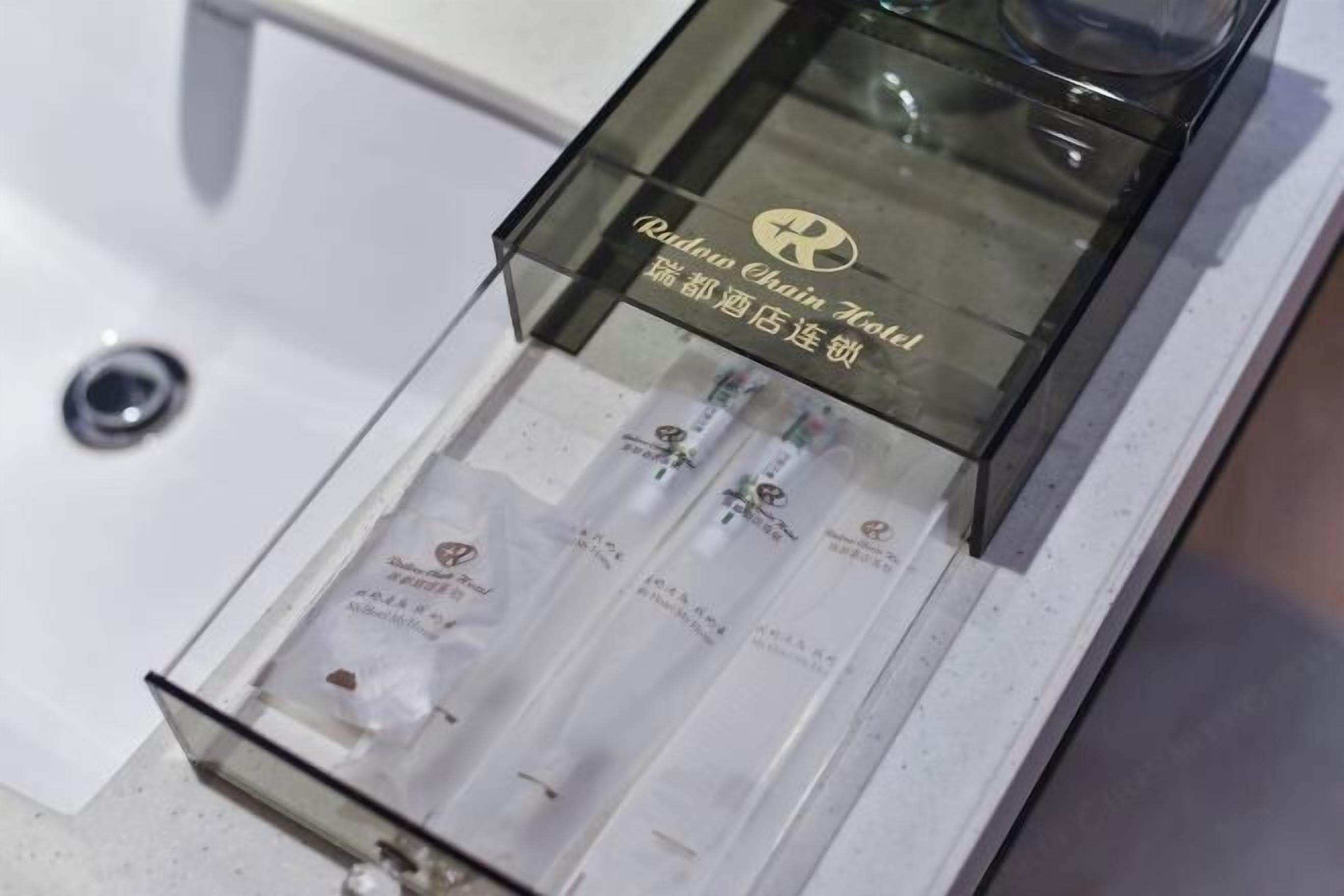 A clear glass display case with a logo and text, likely indicating a hotel's name or brand.