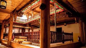 A traditional wooden building with a balcony and intricate carvings.