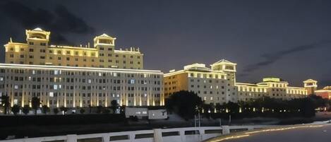 A multi-story hotel with a symmetrical facade, large windows, and a flat roof.