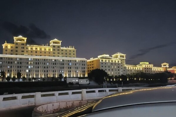 A multi-story hotel with a symmetrical facade, large windows, and a flat roof.