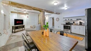 A modern kitchen with white cabinets, a built-in oven, and a refrigerator.