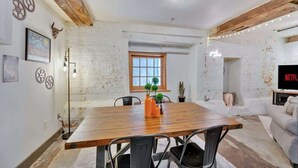 A dining area with a wooden table, chairs, and a window.