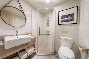 A modern bathroom with a glass-enclosed shower, a white sink, and a toilet. - Manju Hotel (Ningbo Tianyi Square Drum-Tower Subway Station) (Ningbo)