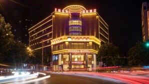A Vienna Hotel with a modern facade, illuminated signage, and a prominent entrance. - Vienna Hotel (Ziyang)