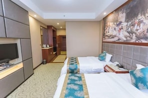 A hotel room with two beds, a television, a painting on the wall, and a bathroom visible through an open door. - Muqing International Hotel (Guilin)