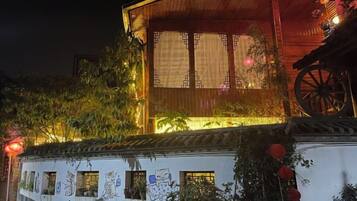 A traditional building with a wooden facade, a large window, and a decorative wheel structure.