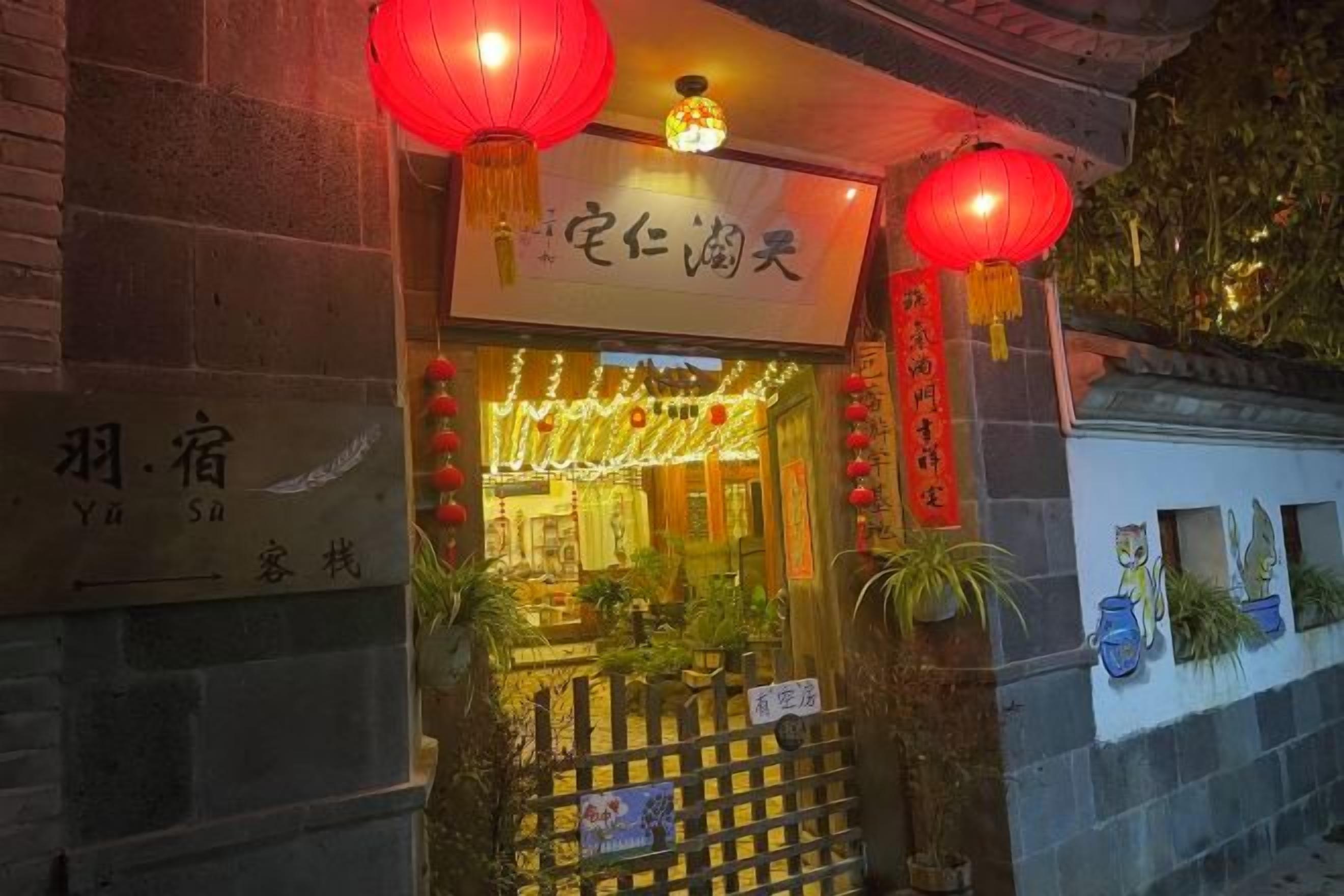A traditional building with a sign indicating a restaurant or eatery. There are red lanterns hanging above the entrance, and the building has a brick facade.
