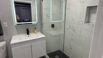 Shower, hair dryer, towels, shampoo