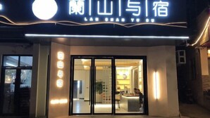 A hotel entrance with a modern design, featuring a large illuminated sign above the entrance and a visible reception area inside. - Lanyu Inn (Yichang Three Gorges Dam) (Yichang)