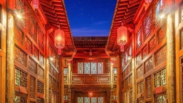A traditional courtyard with wooden architecture, lanterns, and intricate window designs. - Yongyichang Inn (Pingyao County)