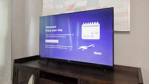 A television displaying a welcome message and a calendar icon, with the Roku logo at the bottom.