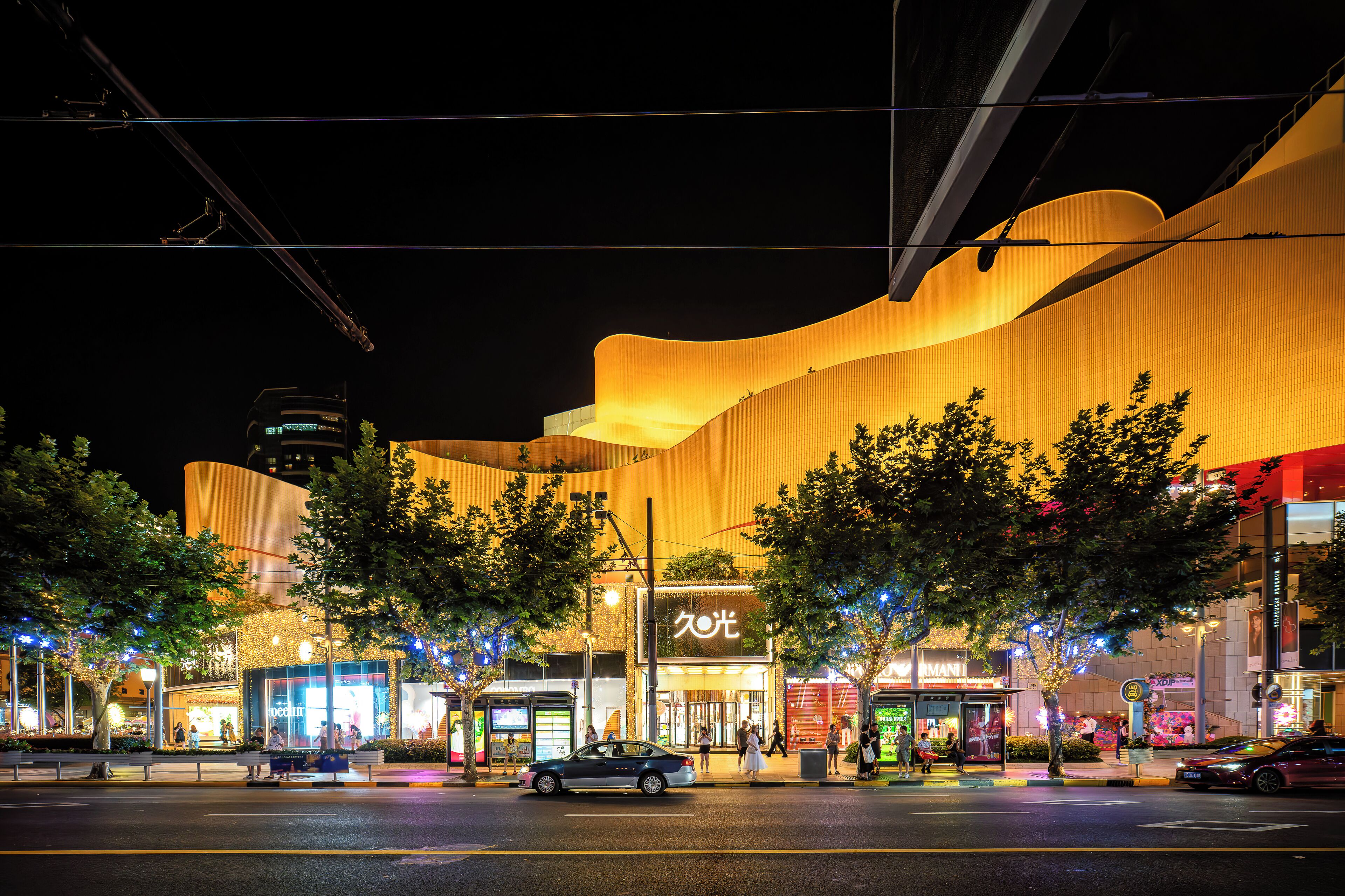 A modern building with a curved facade and a prominent entrance.