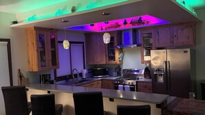 A modern kitchen with a central island, wooden cabinets, and a built-in oven. - Perfect location! Downtown Beach & Ski Pad w/hot tub in the heart of Sandpoint. (Sandpoint)