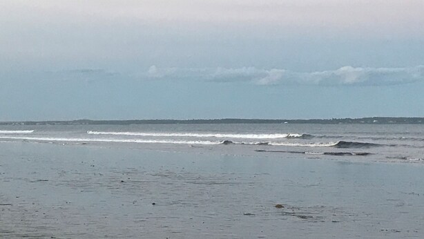 A beach with waves and a distant shoreline. - Idyllic 3 Bed/2Bath condo in Old Orchard Beach, steps to the beach (Old Orchard Beach)