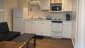 A compact kitchen with white cabinets, a built-in microwave, a stove, and a refrigerator. - Idyllic 3 Bed/2Bath condo in Old Orchard Beach, steps to the beach (Old Orchard Beach)