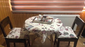 Mini-fridge, stovetop, cookware/dishes/utensils, dining tables