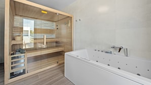 A modern bathroom with a large bathtub, wooden shelves, and a glass enclosure. - Villa MaEm (Istria - Škicini) (Škicini)