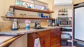 Fridge, microwave, coffee/tea maker, cookware/dishes/utensils