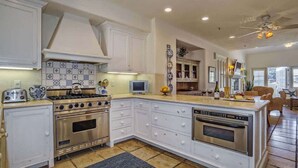 A kitchen with white cabinets, a gas stove, an oven, and a built-in dishwasher. - Santa Barbara Retreat w/ Rooftop Terrace Sleeps 4 (Santa Barbara)