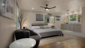 Une chambre à coucher comprenant un lit, une chaise, une table, un ventilateur de plafond, une table de chevet, une commode et une fenêtre donnant sur un paysage agréable.