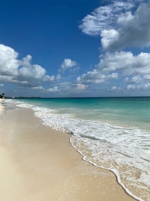 A beach with clear turquoise water and white sand. - Luxurious Beachfront Condo with Breath Taking Ocean, Beach and Garden Views. (Freeport)