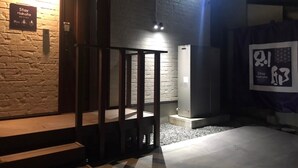 A hotel entrance with a sign reading "Stay Hakata Better!" and a wooden structure in the foreground. - StayHakata villa  (Fukuoka)
