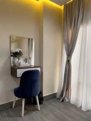 A room with a desk, chair, mirror, and a window with curtains. - Pyramids sunshine view (Giza)