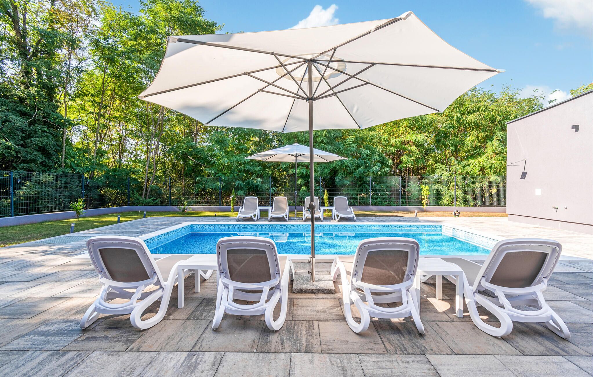 Una piscina amb gandules i para-sols.